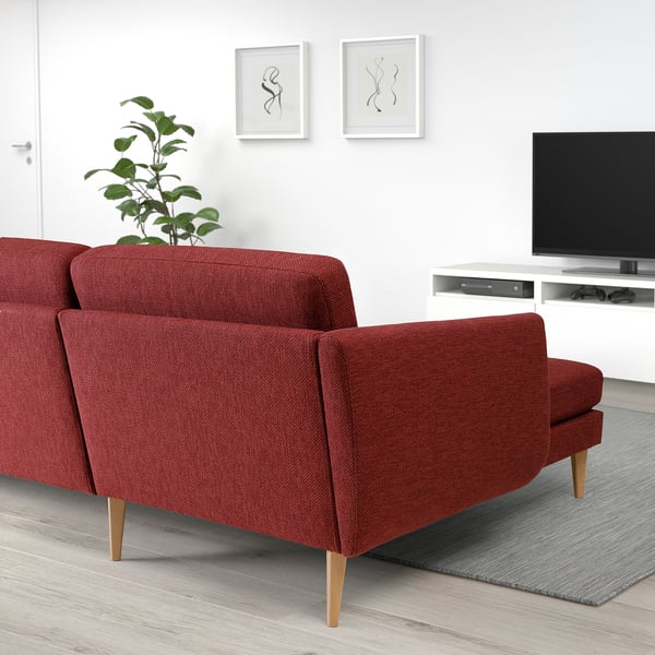 Modern living room with red SMEDSTORP sofa, flat-screen tv, and green plant.