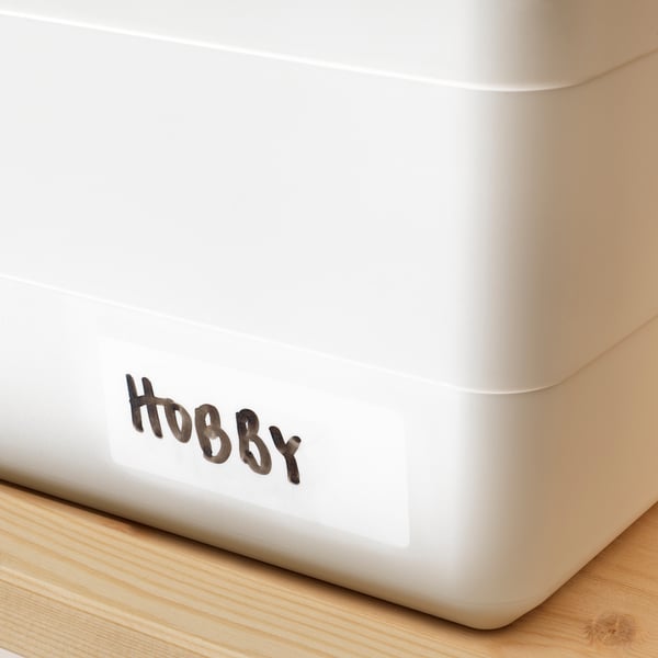 White storage box with hobby label, snap-on lid for dust protection, made from recycled plastic.