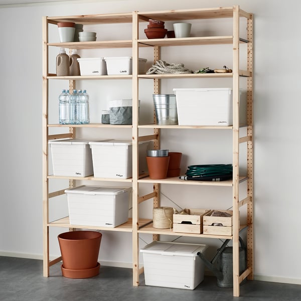 Lightwood shelving unit with multiple white storage boxes and various items neatly organised.