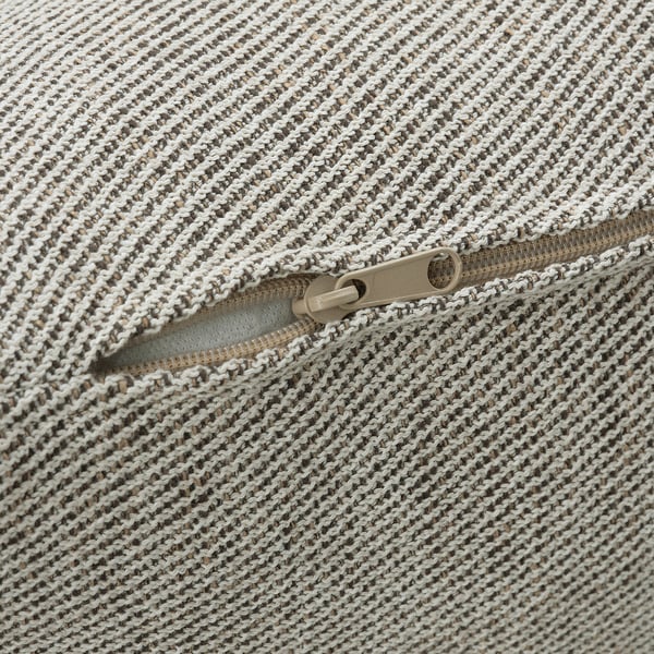 Close-up of textured, zippered fabric in beige and white tones, showing high-quality craftsmanship and detail.