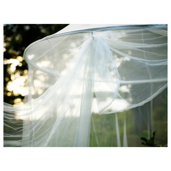White hanging net canopy, likely for relaxation or sleeping, with delicate mesh and soft white lights, providing insect protection.