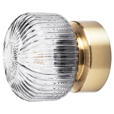 SOLKLINT lamp a striped grey glass shade and shiny brass base, combining modern design with soft mood lighting.