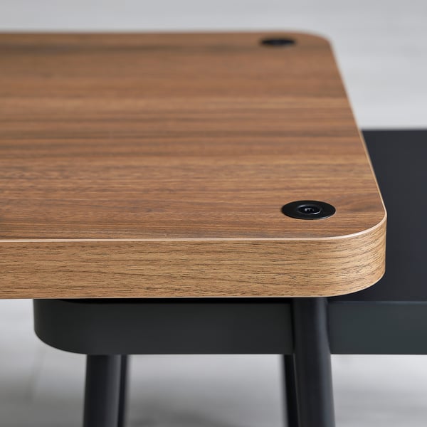 Close-up of modern wooden table edge, smooth finish, and sleek black metal legs. High-quality design.