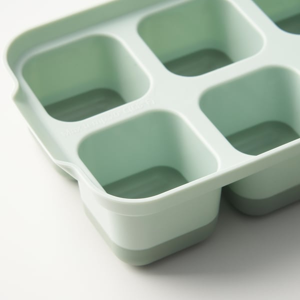 Ice cube tray with lid, white and light green. Flexible design, stackable, easy to remove cubes.