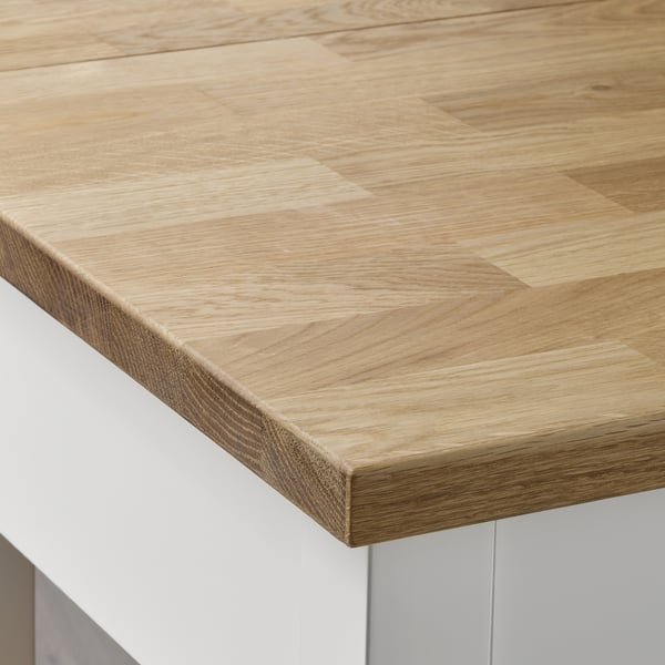 Close-up of a smooth, light wooden tabletop with visible wood grain pattern, showcasing high-quality craftsmanship and natural beauty.