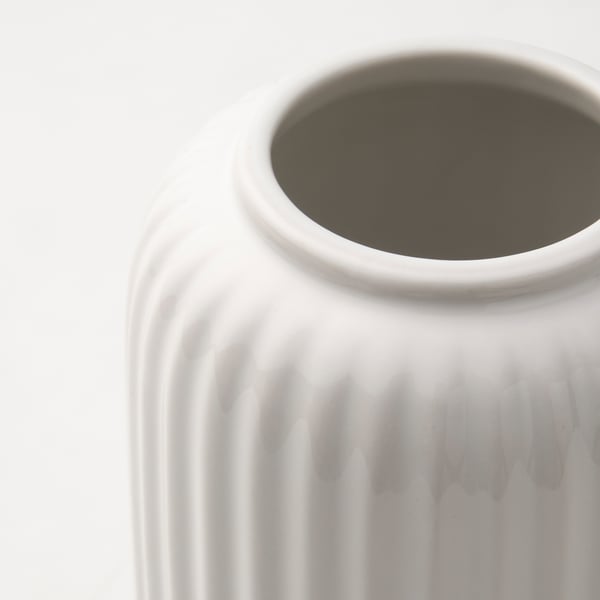 White vase with textured, ribbed surface, clean, minimalist design.