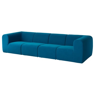 Blue velvet sofa, modern design, soft curves, three cushions, stylish centerpiece.