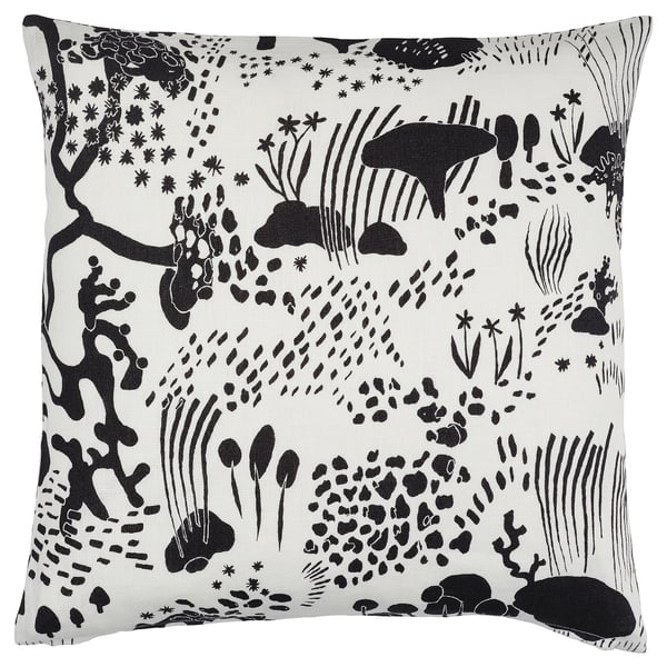 IKEAs white and black STOCKHOLM 2025 linen cushion with nature-inspired forest design, zip closure.