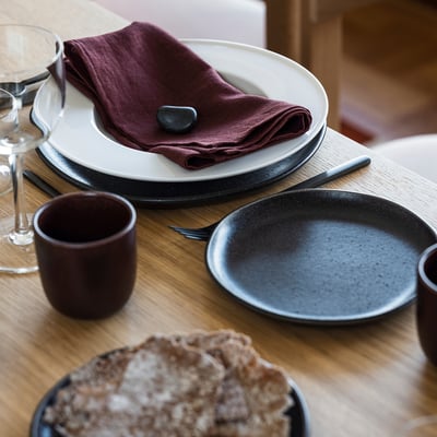 Two identical white porcelain dinnerware plates, flat rim. Elegant, stackable design.