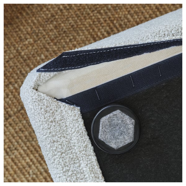 A close-up of a well-crafted sofa, highlighting its durable stitching, supportive foam, and a strong black clip.