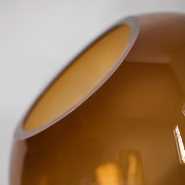 Close-up of a handcrafted brown glass vase, showcasing its high-quality, organic shape and smooth finish.