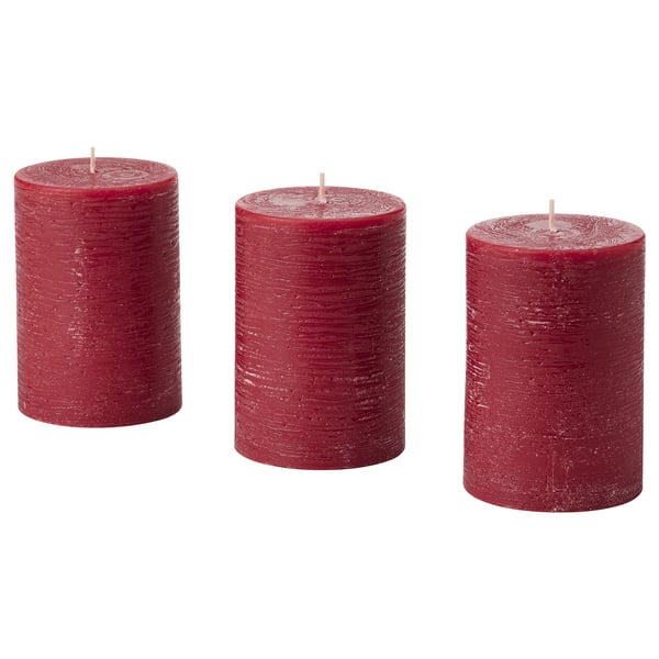 Three red candles, standing upright, cylindrical shape, textured design.