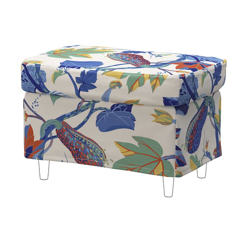 Brightly coloured floral ottoman with potatoes pattern, white legs.