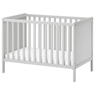 White ikea SUNDVIK baby crib with slatted sides and base, in minimalist modern design.