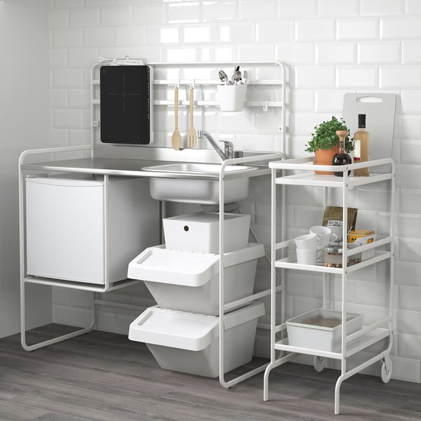 Compact mini-kitchen with sink, storage, and accessories. Ideal for small spaces.