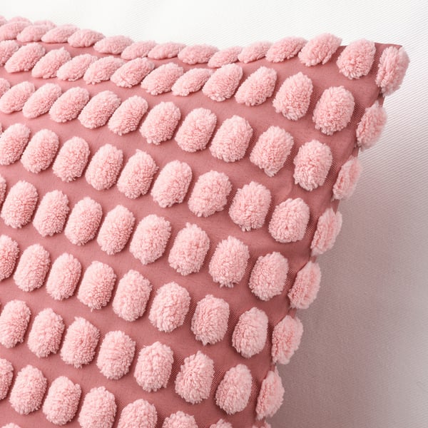 Light pink cushion cover with intricate, textured pattern, crafted from soft, recycled material. Zip closure for easy washing.