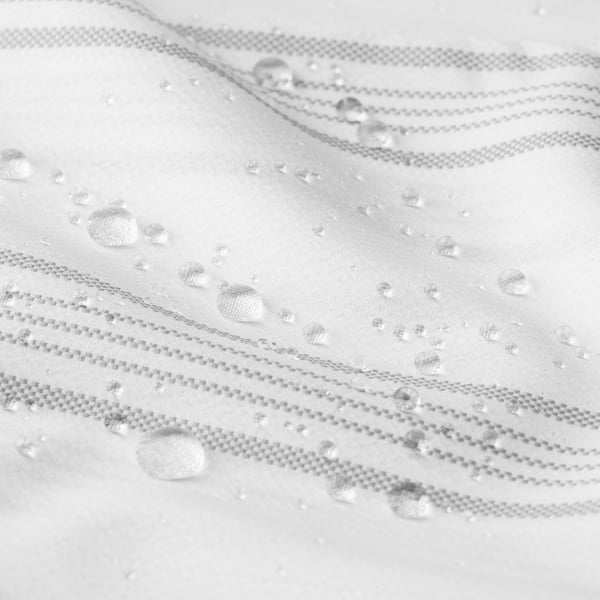 Water-repellent shower curtain with woven stripes, featuring beaded droplets highlighting its water-resistant fabric.