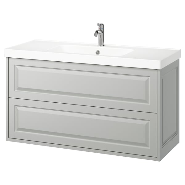 TÄNNFORSEN vanity in light grey with beveled edges. Modern, wall-mounted design with two spacious drawers. White ceramic sink and chrome faucet.