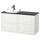 A white TÄNNFORSEN bathroom vanity with black countertop and sink. It classic design with beveled panels and offers ample storage.