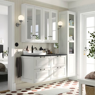 White TÄNNFORSEN bathroom cabinet set in modern design. Drawers, countertop, and sink. Sizable for shared spaces.