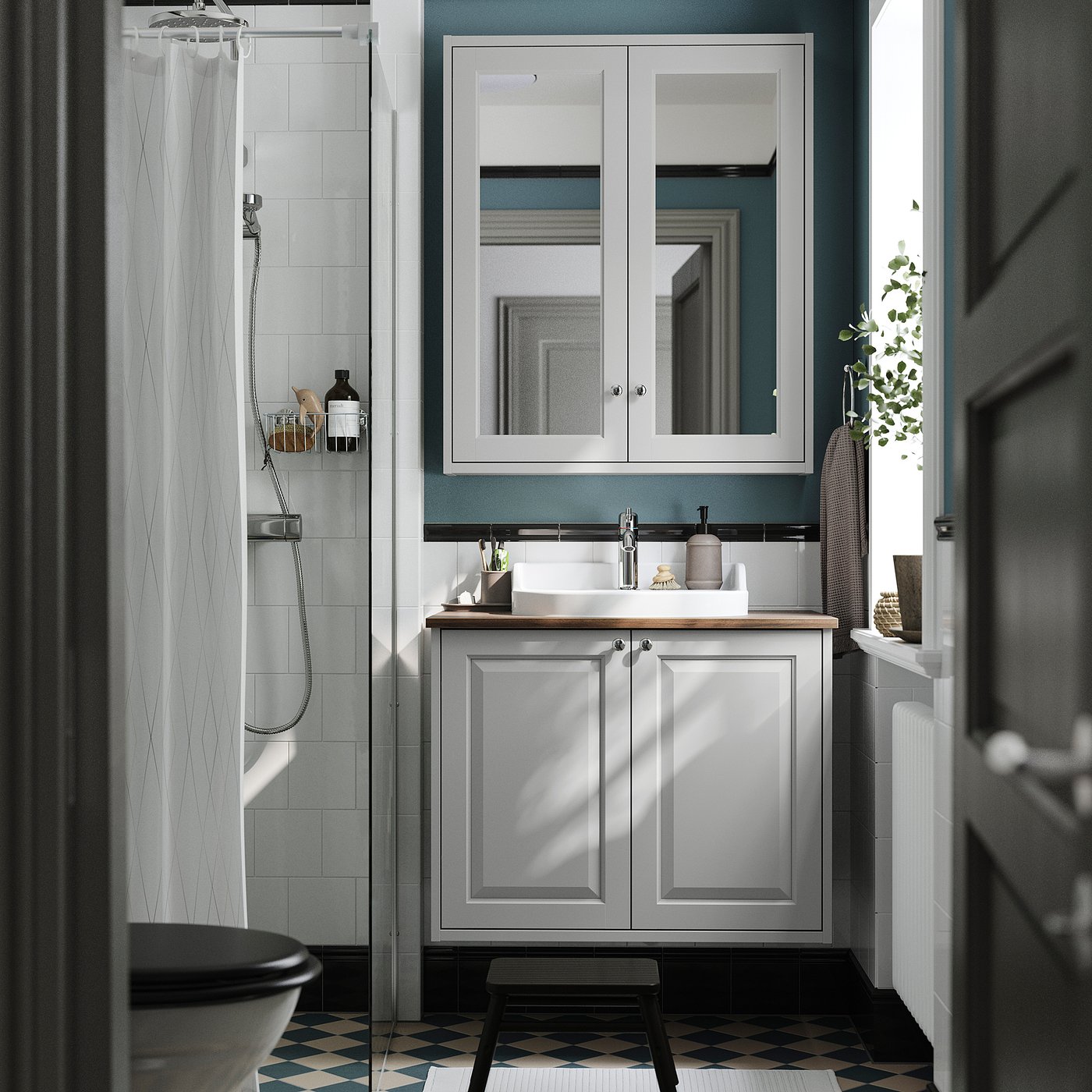 Modern bathroom with grey TÄNNFORSEN vanity, light blue accents, white sink, and black & white patterned floor.