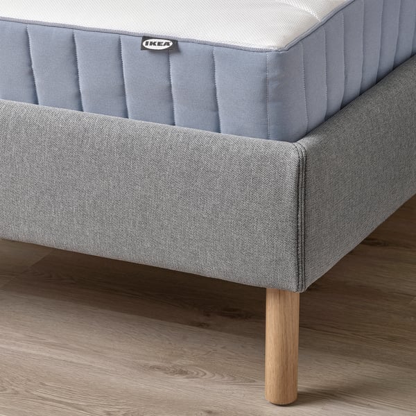 Modern bed frame with padded headboard, wooden legs, and removable, machine-washable cover for easy cleaning.