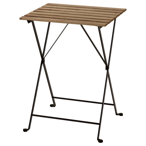 A TÄRNÖ outdoor table with a wooden top and black metal legs, foldable design.