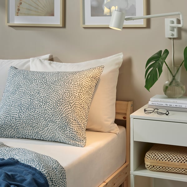 Blue & white TAGGVALLMO bedding in stylish bedroom setting.