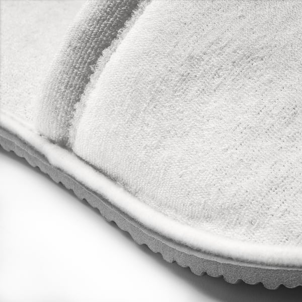 Black and white close-up of a slippers sole, showcasing its textured grip and sturdy design.