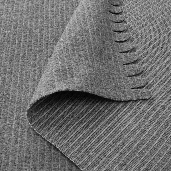 Soft, textured grey fleece blanket folded, showcasing its smooth and cosy fabric.