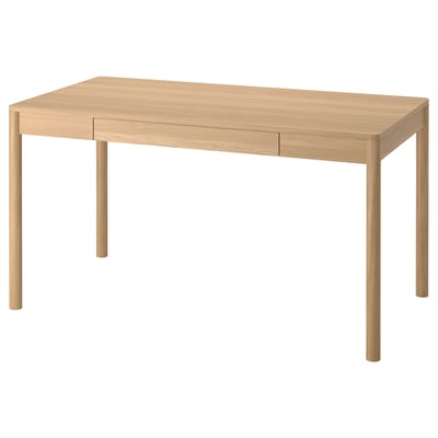 A TONSTAD light brown oak veneer desk with a rectangular shape and minimalistic design. It two narrow drawers and four sturdy legs.
