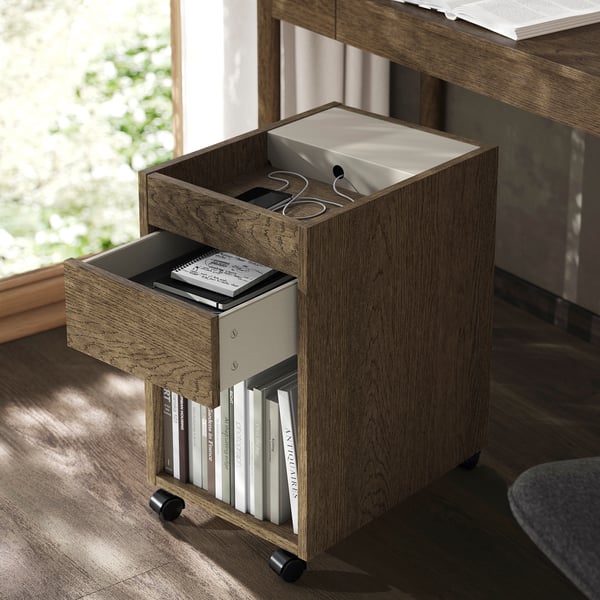 Drawer unit on wheels, open drawers with books.