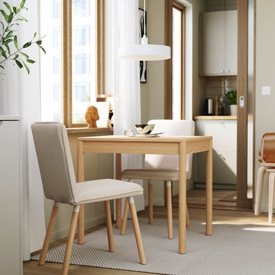 Modern small wooden dining set, TONSTAD. Light table and chairs with nature-inspired design fit under large window.