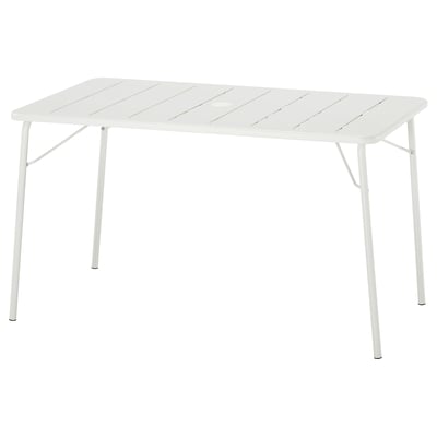 The TORPARÖ dining table is white, rectangular, made of steel with a foldable design for easy storage.
