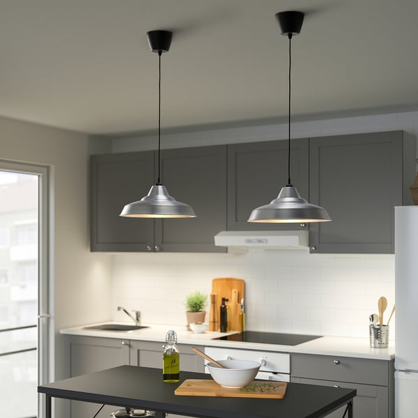 Modern kitchen with TRETTIOEN pendant lamps above island.