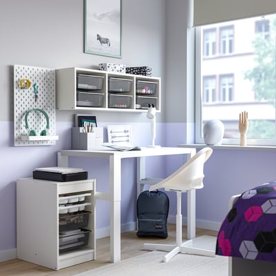 Modern home office with TROFAST storage, desk, chair, accessories, and natural light.