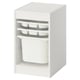 A white TROFAST storage unit with plastic drawers and a bin. Its designed for organizing kids items.