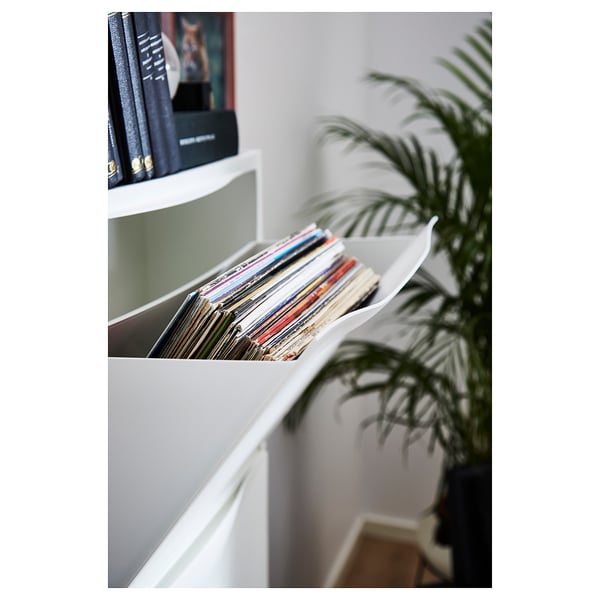 White TRONES storage cabinets with vinyl records and a potted plant.