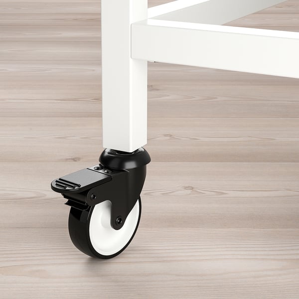 Black and white caster wheel attached to white table leg.