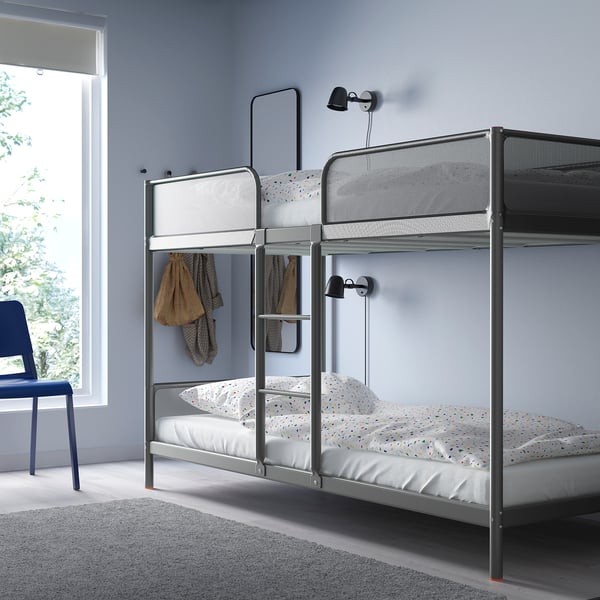 TUFFING silver bunk bed by window, modern minimalist design, fits lower, grey linens, wall lamps.