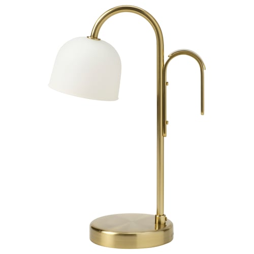 A brass-colored TVÅMASTAD lamp with a frosted glass shade. Its a stylish, portable led lamp with a curved handle and base, designed for easy movement.