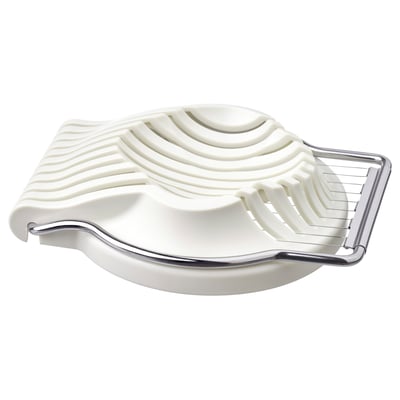 A white UPPFYLLD egg slicer with stainless steel accents, designed for slicing eggs and other soft foods.