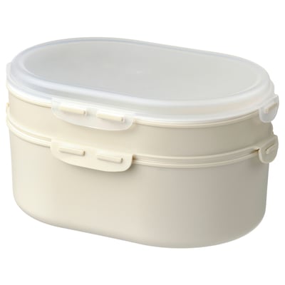 A white, oval-shaped, two-tiered plastic lunch box with a clear lid, designed for stacking and separating food items.