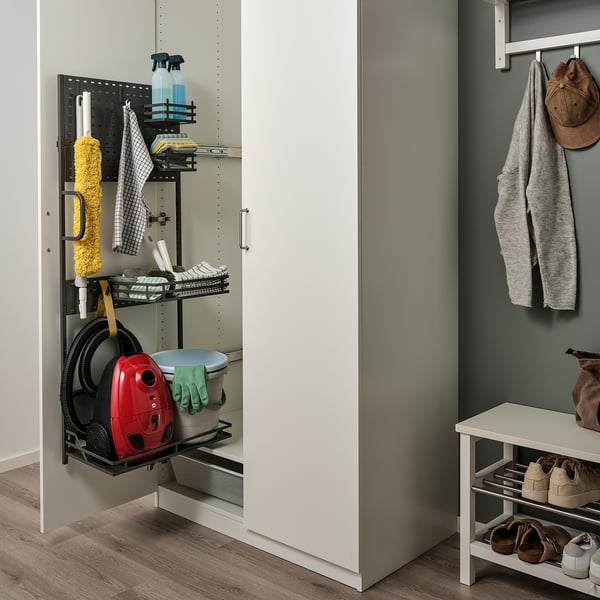 Organised cleaning supplies on pull-out shelf in cabinet.