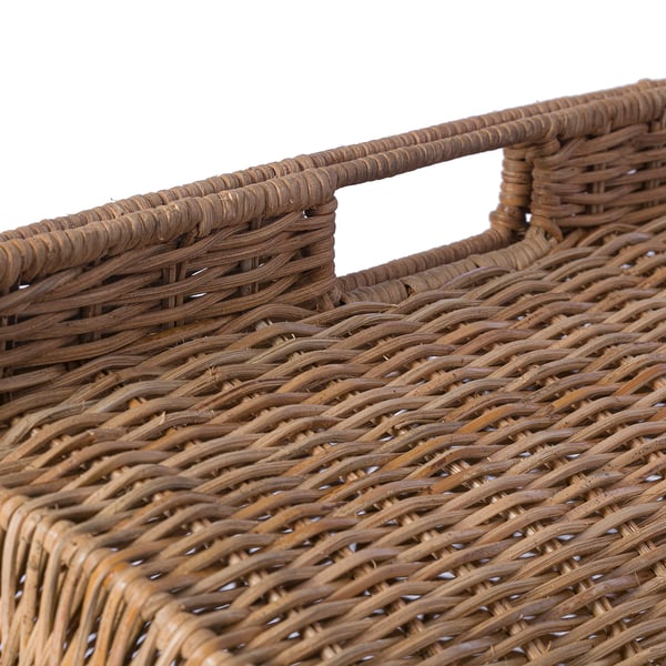 Handwoven rattan basket with sturdy handles, showcasing intricate craftsmanship.