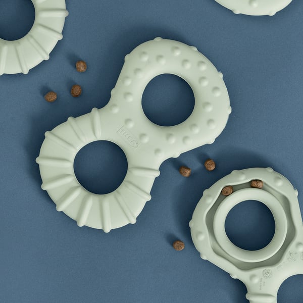 Light blue dog toys scattered on a blue surface; designed for hiding treats, encouraging play and interaction.