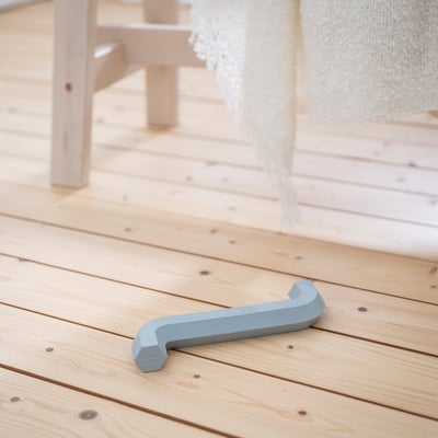 Light blue UTSÅDD dog toy on wooden floor, shaped like an allen key, small size.