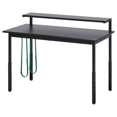Black UTVISNING gaming desk with adjustable height, monitor shelf, and green cable straps, designed for compact spaces.