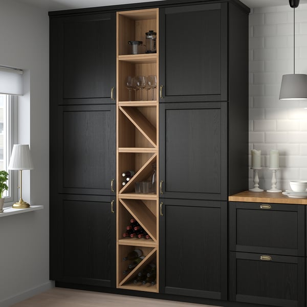 Large black VADHOLMA wine storage cabinet holds bottles & glasses, adding rustic charm to modern kitchens. Tall, fits in corner, open middle shelves.