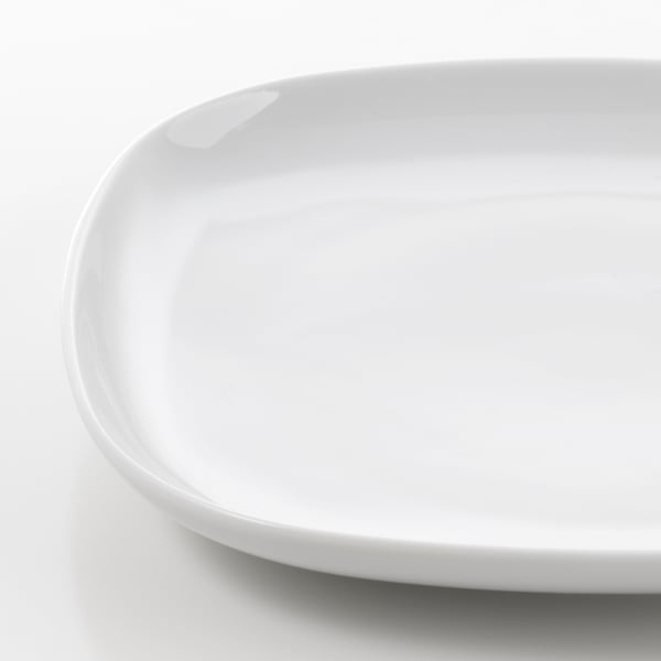 Close-up of smooth, glossy white porcelain plate edge. Shows fine craftsmanship and durability.